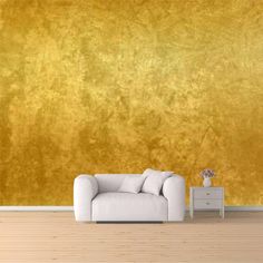 a living room with a couch, table and gold wall