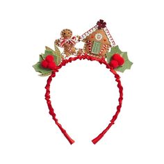 a red headband with a gingerbread house and holly leaves on the side, topped with a teddy bear