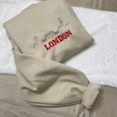 London Embroidered Crewneck/Sweatshirt  Hello there! Please message me if you have any additional questions or want to change thread colors. We are a family-run Etsy page; my husband and I make all orders from home. You can also send us a message if you would like a custom sweatshirt/t-shirt with whatever words and images, and we will see if we can accommodate your order! HOW TO ORDER - Please Choose the SIZE and COLOR From Drop Down Menu. MATERIAL - We use Jerzee and Gildan as our blanks; I may Long Sleeve Tops With Machine Embroidery For Streetwear, Machine Embroidered Cotton Sweatshirt For Streetwear, Cotton Sweatshirt With Machine Embroidery For Streetwear, Embroidered Crew Neck Relaxed Fit Hoodie, Embroidered Relaxed Fit Crew Neck Hoodie, Cream Cotton Sweater With Embroidered Logo, Cream Cotton Sweatshirt With Embroidered Logo, Relaxed Fit Embroidered Cream Sweatshirt, Cotton Loungewear Sweater With Embroidered Text