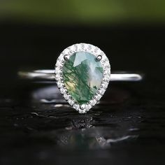 a pear shaped green and white diamond ring