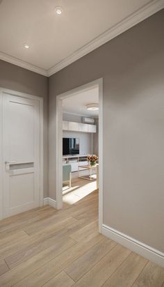 an empty living room with hard wood flooring