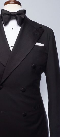 The classic black tuxedo is a staple of any man's wardrobe. This elegant double-breasted Evening Wear tuxedo is tailored slim from soft, mid-weight, deep black mohair, and features our signature double-breasted 2x6 button placement, double vents, jetted pockets, natural shoulder, and wide peak lapels in grosgrain. The accompanying slim trousers are flat front with a wide waistband and feature our versatile side adjusters and classic tuxedo stripe. Double Breasted Tuxedo Men, Classic Black Tuxedo, Cool Tuxedos, Red Overcoat, Men Tuxedo, Navy Blue Tuxedos, Grey Overcoat, Double Breasted Tuxedo, Prom Tuxedo