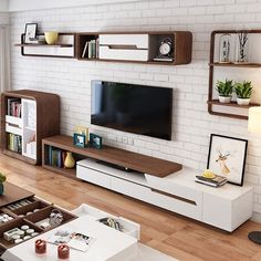 a living room filled with furniture and a flat screen tv on top of a wooden shelf