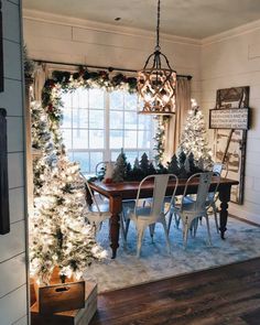 the dining room is decorated for christmas with white lights and garland on the windowsill