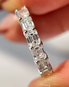 a close up of a person holding a diamond ring