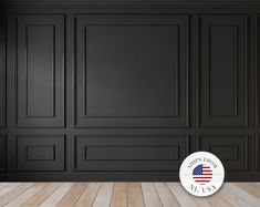 an empty room with black walls and wood flooring in the foreground, there is a round sticker that says happy labor day