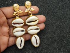 This listing is for 1 pair of Cowrie Shell Earring Cowrie Brass earring Gold plated Cowrie Shell earring Bridesmaid charm earring Unique Fashion jewelry Bohemian.Size:  81  mm long.Made with Love♥Best for gift .Light Weight comfortable to wearMany thanks for you visit my store ♥ if you have any question please contact us.For wholesale Price Please Convo me.You can order different items as many you like . White Alloy Earrings For Wedding, White Alloy Wedding Earrings, White Alloy Drop Earrings, White Dangle Alloy Earrings, White Alloy Dangle Earrings, White Plated Drop Earrings, Handmade Elegant Alloy Earrings, White Alloy Pierced Earrings, Handmade Alloy Drop Earrings