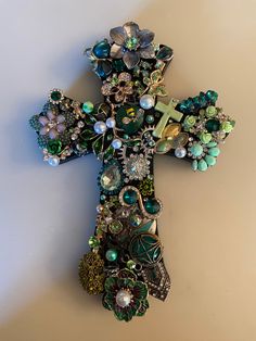 You have chosen a one of a kind creation crafted from beautiful vintage, costume, faux vintage and modern day jewelry.  The wooden painted cross was chosen to accentuate the design. This unique ornament design is ready to hang on a wall or on your Christmas tree. Your family and friends will love the charm it adds to any room.  Your design would make a great family keepsake or heirloom to pass on through the years or a special gift for any occasion. Size is approximately 8" x 6" x 1/2" Thank you Wooden Cross Crafts, Old Jewelry Crafts, Costume Jewelry Crafts, Jeweled Christmas Trees, Vintage Jewelry Ideas, Jewelry Frames, Jeweled Christmas, Cross Crafts, Vintage Jewelry Crafts