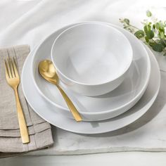 white plates and silverware on a linen placemat