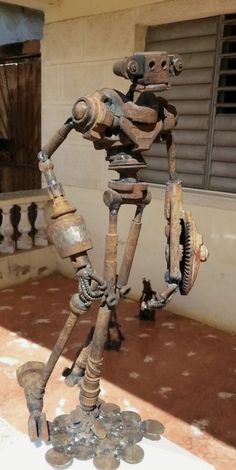 a metal skeleton is standing on top of coins in front of a window with shutters