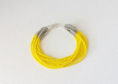 "Yellow and silver bracelet. You receive ONE bracelet. You can choose from 7 different sizes at checkout. ❤ SIZES This item comes in several sizes, kindly choose at checkout. The easiest way to find out which length suits you best is to measure a bracelet you already own, from one end to the next, including clasp. You can use a ruler or any measuring device at home. The standard size for an average woman is 7\". For a child, perhaps a 6\" would be appropriate. If you'd like a clasp extender beca Yellow Bracelet Beads, Yellow Beaded Bracelet, Multistrand Bracelet, Yellow Bracelet, Necklace Ideas, Seed Bead Bracelet, Multi Strand Bracelet, Bohemian Bracelets, Boho Bracelet