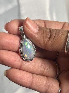 Embrace your best self with these magical Ethiopian Opal pendants. The brilliant southwest-styled setting and glowing teardrop stone make this exquisite pendant an excellent statement piece. Opals have been revered by many cultures for their unique mystical beauty and the belief that they protect against negative energy and soothe sadness. This lustrous pendant adds a touch of splendor to any outfit with its fiery hues. You won't be disappointed. Materials: .925 Sterling Silver, Ethiopian Opal A Traditional Teardrop Gemstone Jewelry, Spiritual Teardrop Pendant Large Jewelry, Handmade Teardrop Opal Jewelry, Traditional Sterling Silver Teardrop Pendant Jewelry, Spiritual Healing Teardrop Pendant Jewelry, Bohemian Teardrop Pendant Jewelry With Large Stone, Bohemian Teardrop Jewelry With Large Stone, Bohemian Teardrop Pendant With Large Stone, Bohemian Teardrop Large Stone Jewelry