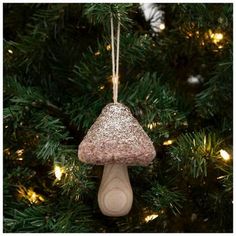 an ornament hanging from a christmas tree in the shape of a small mushroom