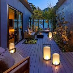 an outdoor deck with candles lit up on it