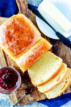 slices of bread on a cutting board with jam and butter