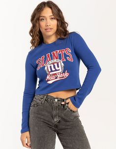 Nfl New York Giants Long Sleeve Baby Tee. Large Graphic Screened On Front. Small Graphic On The Back Of The Neck. Ribbed Crew Neckline. Long Sleeves. Cropped Fit. 94% Cotton, 6% Spandex. Machine Wash. Imported.officially Licensed.model Is Wearing A Size Small Model Measurements:height: 5'7" Bust: 32"waist: 25"hips: 36" Ny Giants Outfit Women, Fitted Tops For Game Day In Spring, Blue Tops For Fall Game Day, Trendy Crew Neck Top For Game Day, Spring Game Day Top With Text Print, Blue Letter Print Top For Game Day, Blue Letter Print Tops For Game Day, Blue Fitted Top For Game Day, Spring Long Sleeve Tops For Game Day