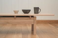 two bowls are sitting on a wooden table