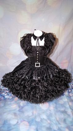 Luxury Wednesday Addams inspired tutu dress. Collar included. Dip hemmed skirt so knee length in the front going to floor length at the back. The top consists of a glitter material panel which is decorated. All of my tutus are made to order and consist of four layers of polyester tulle which makes it lovely and full. I use a combination of plain tulle and sequin tulle which gives the added wow factor.  My tutus are made on unlined crochet tops and glitter panels are added to the front. The tops are also felt backed to ensure the design does not cause any irritation to your little one. This tutu is designed at ankle length so if you could provide me with the measurement from waistline to ankle, I can make the dress accordingly. Made to order only. Sponge clean only, cannot machine wash. Bei Halloween Corset Dress With Ruffles For Cosplay, Fitted Punk Halloween Costume, Halloween Witchy Overbust Corset Dress, Punk Style Corset Dress For Halloween Party, Gothic Ruffled Corset Dress For Costume Party, Fitted Black Gothic Costume, Witchy Overbust Corset Dress For Halloween, Witchy Halloween Overbust Corset Dress, Black Fitted Gothic Costume