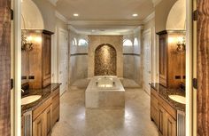 a large bathroom with two sinks and a bathtub in the middle of the room