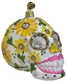 a white skull with yellow flowers on it