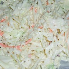 cabbage and carrots are mixed together in a bowl