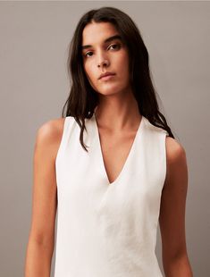 Made from a soft linen blend, this dress has a weightless feel. Styled with a sleeveless silhouette and a V-neckline. Defined with a clean shape and refined seaming details at the back, this piece is a modern wardrobe staple that can be dressed up or down.  Material: 40% Cupro, 35% Linen, 25% Cotton.