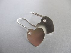 "These earrings are perfect for Valentine's day or any or any gift occasion. I cut the hearts out of sterling silver sheet with my little saw and gave them a soft brushed surface. The ear wires are handmade of sterling silver with a little ball at the end which shows at the front of the heart. Simple, elegant, and sweet. The hearts measure approx. 5/8\" by 5/8\" (16mm by 16mm)" Silver Heart Earrings For Anniversary On Valentine's Day, Silver Earrings For Mother's Day Anniversary Gift, Silver Earrings For Anniversary, Mother's Day Gift, Silver Heart Earrings For Anniversary Gift, Silver Heart Earrings For Anniversary, Silver Heart Shaped Earrings For Anniversary, Sterling Silver Earrings For Anniversary, Sterling Silver Earrings For Mother's Day Anniversary, Sterling Silver Earrings For Anniversary And Mother's Day