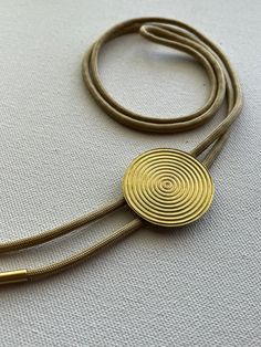 Golden brass Inner Circles bolo tie necklace on light gold colored nylon cord. Bolo Tie Necklace, Crescent Earrings, Light Gold Color, Tie Necklace, Bolo Ties, Inner Circle, Bolo Tie, Mixed Metals, Raw Brass