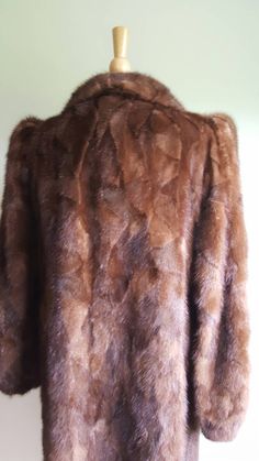 Old Hollywood glamour ✨📸 This vintage 1940s-style glossy mink coat features dramatic puffed sleeves, with padding at shoulders for structure and lift and elasticized wrists; a face-framing portrait collar; a deco-inspired geometric pattern to the fur; two pockets; and a sleek, longer length. Hidden front hook closures, fully lined. Monogrammed CHC. Era: 1960s Label: Strouss Pictured on a US size 6/8 dress form. ➸ visit on instagram | provenance_vintage Brown Winter Wedding Outerwear, Winter Wedding Brown Outerwear, Elegant Brown Long Fur Coat, Elegant Long Brown Fur Coat, Formal Brown Fur Coat For Fall, Brown Winter Fur Coat For Formal Occasions, Brown Fur Coat For Formal Winter Occasions, Bear Coat, Leopard Coat