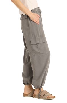 Slip into streetwear style with these roomy cargo pants cut from a lightweight fabric and designed with drawstrings at the waist and hems. 27" inseam; 10 3/4" front rise; 13 1/2" back rise Elastic/drawstring waist Front welt pockets; back patch pockets; cargo flap-patch pockets 100% lyocell Machine wash, tumble dry Imported Relaxed Fit Linen Cargo Style Bottoms, Relaxed Fit Linen Cargo Pants With Pockets, Relaxed Fit Linen Cargo Bottoms, Casual Linen Parachute Pants With Cargo Pockets, Linen Wide Leg Parachute Pants With Side Pockets, Wide Leg Linen Parachute Pants With Side Pockets, Casual Linen Pants With Multiple Pockets, Utility Linen Cargo Pants With Cargo Pockets, Linen Utility Bottoms With Side Pockets