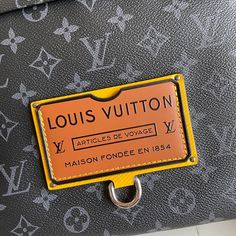 a louis vuitton bag with an orange label on it