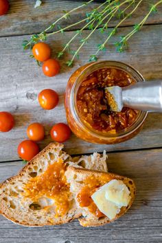 an open sandwich with tomato sauce and cheese on it next to some cherry tomatoes,