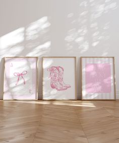 three framed pictures on the wall in front of a wooden floor with light coming through