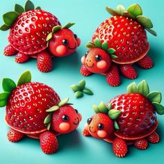 three red strawberries with green leaves on them and two smaller ones sitting next to each other