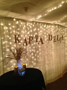 a room with lights on the wall and a table in front of it that says kappa dela