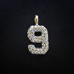 A classic piece at an unmatched price. GLD's Number Pendants are sure to catch everyone's attention with a fully iced face of handset stones. Represent any important date in your life with a custom pair of numbers. Discount codes NOT valid on solid gold orders. We cannot accept returns on made to order solid gold items. Please allow up to 2-3 weeks for production on this custom piece. Specifications - 1" x 1 1/2" (Pendant Width x Height) - Weight: (Weight can vary +/- 3 grams) - 10k Solid Gold: Iced Face, Gold Items, Cross Earrings Studs, Number 9, Gold Number, Vermeil Jewelry, Custom Earrings, Pendant Bracelet, Chain Earrings