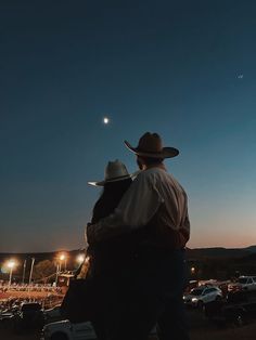 two men in cowboy hats standing next to each other