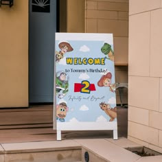 a welcome sign for two years old with cartoon characters on it and the number 2