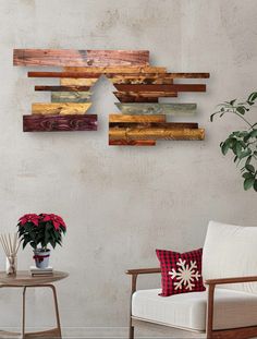 a living room filled with furniture and a wooden christmas tree on the wall next to a potted plant