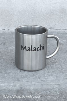 a stainless steel mug with the word malachi on it