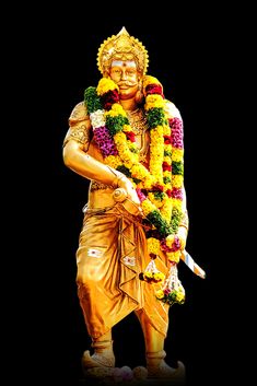 a statue of a man with flowers around his neck and hands in the other hand