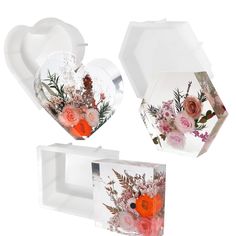 three boxes with flowers in them on a white background