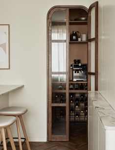 a wine rack in the corner of a kitchen