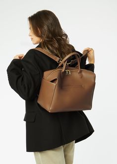 Emmy Midi is a “just right” sized tote-style diaper bag with the same features as the full-sized version, so everything you and baby need is easy to see and reach. Our microfiber vegan leather makes Emmy structured yet slouchy and is so durable that it doesn’t need to be babied. She works best as a shoulder bag or crossbody but can be converted to a backpack when you want to be hands-free. From jeans and sneakers to yoga pants or a party dress, Emmy’s clean lines enhance any style. Common Uses: Vegan Leather Backpack, Everyday Purse, Matte Black Hardware, Gold Sand, Gear Bag, Best Bags, Backpack Straps, Crossbody Tote, Black Hardware