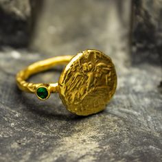 Ancient Greek Owl Athena Coin Ring | 24K Gold Plated 925 Sterling Silver | Gold Greek Athenian Tetradrachm Ring | Handmade Ring Our shop offer free ring sizing and color options.(Oxidized(Black),Gold Plated) Handcrafted hammered full round ring band size measures 2mm in width and 24k gold plated bronze coin 14.5x14.5 mm Metal : 925 Sterling Silver Plated : 24K Gold Band Width : 2 mm Gem Stone : Green Diamond Cut Cubic Zirconia Gem Color : Green,Navy Blue,Purple,Blue,White,Red (The color you want Ancient Greek Ring, Ancient Rings, Ancient Greek Jewelry, Greek Ring, Gold Armband, Greek Jewelry, Bronze Ring, Coin Ring, Ancient Jewelry