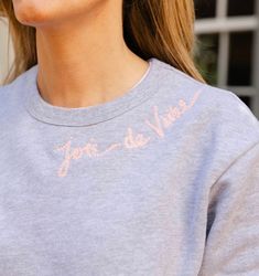 a close up of a person wearing a shirt with writing on the front and back