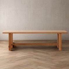 a wooden table sitting on top of a hard wood floor next to a white wall