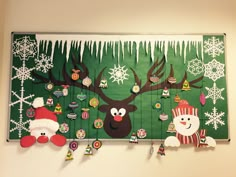 christmas decorations are hanging on the wall with reindeers and snowflakes around them