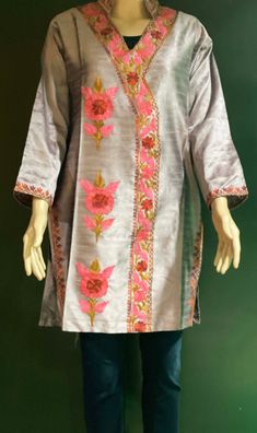 Embroidered Tunic Crafted from raw Silk, designed in Classic Kashmiri Aari embroidery.  Match it with a pair of denims or leggings perfect for Women and Girls a classic tunic that never goes out of fashion. ThisTunic features intricate  embroidery on the neckline, sleeves, the side hem and motif on the front. A combination of vibrant shades with a beautiful play of colors. Color: silk Pink -Color can vary due to lighting. All sizes  are approx.  Size: USA, M  Chest:38 inch.  Shoulder: 17 inch.  Sleeve length: 18 inch  Length: 33 inch. Fabric: Raw Silk- Dry clean or hand wash, iron on low heat. Made in a smoke and pet free home. Made in Kashmir, India Designer Embroidered Raw Silk Dress, Floral Embroidered Straight Kurta For Eid, Designer Embroidered Dress In Raw Silk, Traditional Festive Embroidered Tunic Dress, Spring Traditional Wear With Multicolor Embroidery And Long Sleeves, Eid Embroidered Floral Straight Kurta Dress, Floral Embroidered Straight Kurta Dress For Eid, Festive Resham Embroidered Tunic Top, Eid Floral Embroidered Straight Kurta Dress