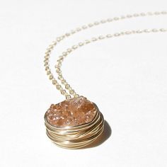 "Lovely and organic inspired 14K Gold druzy necklace in an eye catching, shimmering peach.  Dangling from a 14K gold filled necklace is a genuine druzy quartz gemstone which has been hand wire wrapped creating a bezel setting. ►Matching earrings:  https://www.etsy.com/listing/184174000/14k-gold-peach-druzy-earrings-champagne ►All Sela + Sage jewelry comes in a gift box wrapped in a silvery ribbon - making the perfect gift. ►Message for customization - all items are hand made, therefore designs a Sunstone Gemstone Necklace For Gift, Sunstone Gemstone Necklace As A Gift, Rose Gold Pendant With Natural Stones, Rose Gold Natural Stones Pendant Jewelry, Rose Gold Pendant Jewelry With Natural Stones, Spiritual Sunstone Jewelry For Gift, Spiritual Sunstone Jewelry As A Gift, Rose Gold Wire Wrapped Round Pendant Jewelry, Sunstone Gemstone Jewelry As Gift